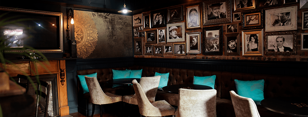 Moody Culture Club booth interior with teal chairs